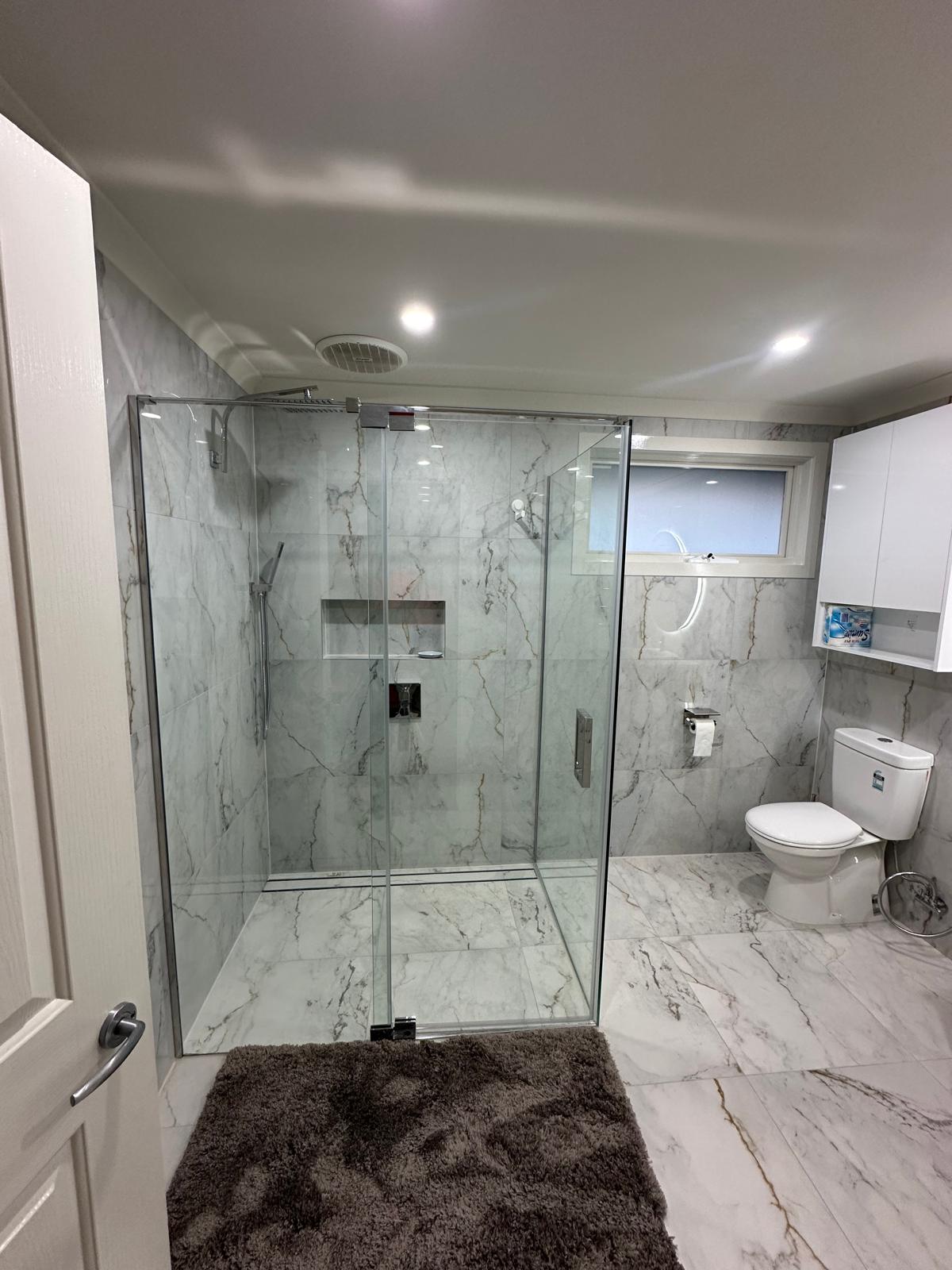 Spacious walk-in shower with premium glass screen and fixtures